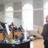Man speaks to an auditorium full of people