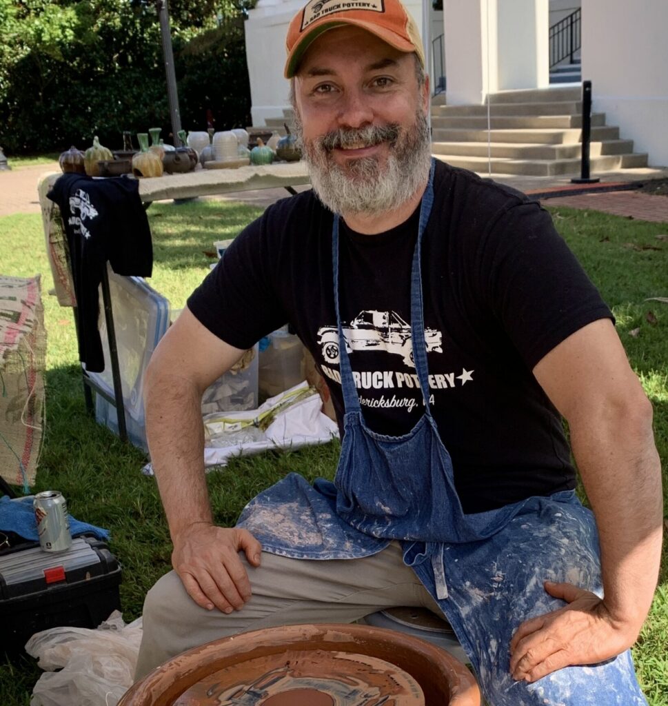 Man sitting at potter's wheel