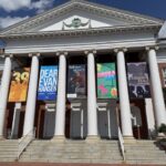 duPont Hall at UMW on a sunny day with banners hanging for the year's productions